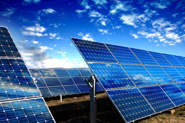Blue solar panels Photo voltaic solar panels and blue sky with clouds